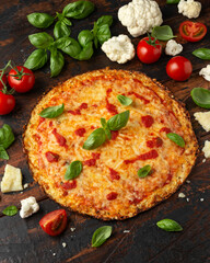 Cauliflower crust pizza with tomato sauce, cheese and basil. Healthy diet food