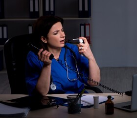 Aged female doctor working at night shift