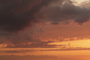 Fototapeta na wymiar Soft clouds with orange light during summer sunset