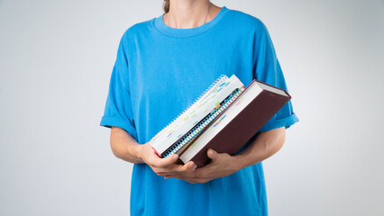 Subjects for study - a set of books, notebooks and notebooks in hand