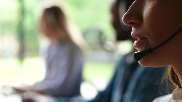 Young woman customer care support service agent call center operator in wireless headset talk consult online client using computer solving complaints on helpline or sell services in telesales office