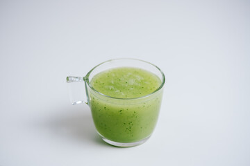 Kiwi and orange blended fruit juice with isolated white background.