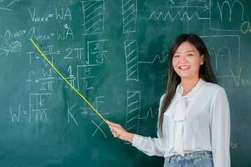Portrait attractive of smiling Asian Teacher woman teaching student in physics classroom, Female teacher writing on blackboard, High school and back to school concept.