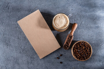 Fototapeta na wymiar Coffee identity branding mockup. Blank brown craft bag with coffee beans and cup of coffee. Package mockup template for logo, brand, sticker, label. Top view, flat lay