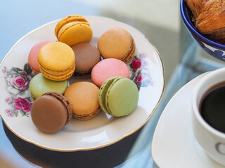 Colorful french macaroons on a beautiful vintage plate. 
