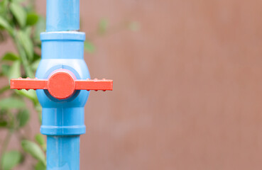 Blue water valve connected to the PVC pipe with copy space, Selective focus on the water valve.