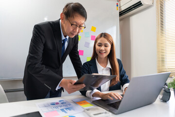 Business partnership concept, Businesswoman is typing on laptop during senior explain project data