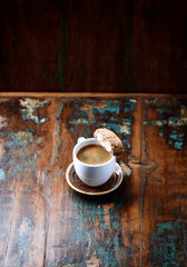 Cup of coffee and Cantuccini (Italian cookie) on dark wooden background. Copy space.