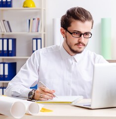 Young male architect working in the office