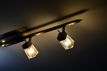Bright colorful lighting, an original metal chandelier with small lamps is installed on the ceiling...