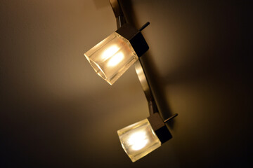 Bright colorful lighting, an original metal chandelier with small lamps is installed on the ceiling...