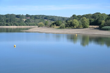 Fototapeta na wymiar A low waterline showing drought conditions at Ardingly Resevoir in West Sussex during the summer of 2022 on the 07 August. 