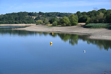 Fototapeta na wymiar A low waterline showing drought conditions at Ardingly Resevoir in West Sussex during the summer of 2022 on the 07 August. 