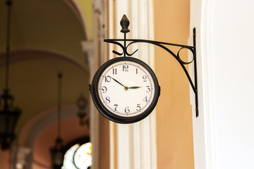 Old analog clock on building wall outdoors