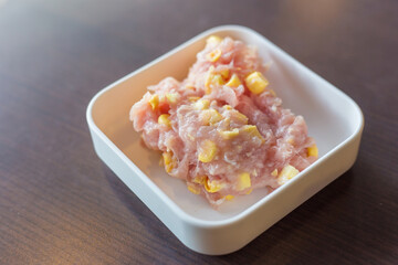 Butacorn, minced pork mixed with corn flavored, mellow, delicious was served for Sukiyaki and Shabu or Yakiniku restaurant which it put on white plate.