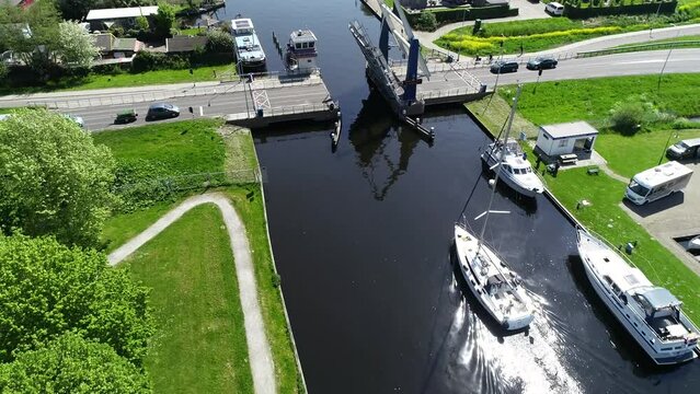 Aerial view of picturesque dutch city Lemmer and bascule bridge in the summer. Sailboats and yachts pass under the drawbridge. Famous place to visit in Holland. 