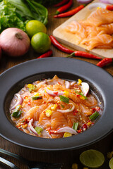 Spicy Salmon Salad on wood background