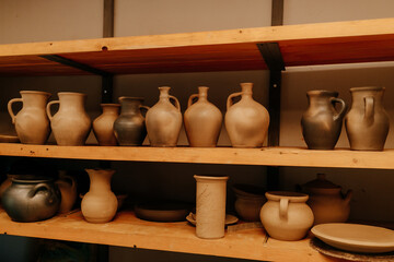 Fototapeta na wymiar many clay pots on shelves in a pottery. High quality photo