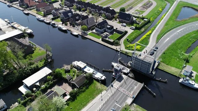 Aerial view of picturesque dutch city Lemmer and bascule bridge in the summer. Sailboats and yachts pass under the drawbridge. Famous place to visit in Holland. 