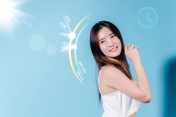 Smiling asian beauty woman hold sun cream with sun protection uv or sunscreen, sun block on the blue background