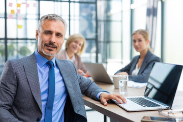 Fototapeta premium Businessman with colleagues in the background in office.