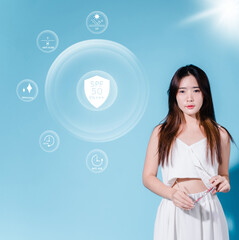 Charming asian beauty woman hold sun cream with sun protection uv or sunscreen, sun block on the blue background