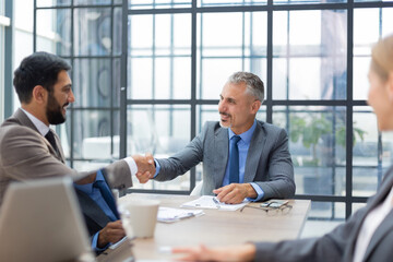 Business people shaking hands, finishing up a meeting.
