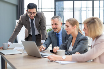 Group of business partners discussing ideas and planning work in office.