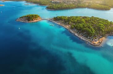 Camping, vacation concept. Beautiful Medulin aerial view. Top view from drone of coastline at sunset to a tent city on a peninsula, colorful seascape, Croatia
