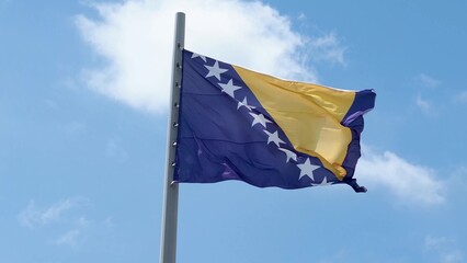 Bosnia and Herzegovina, flag is fluttering in the wind photo on the background of the sky, outdoors. National flag