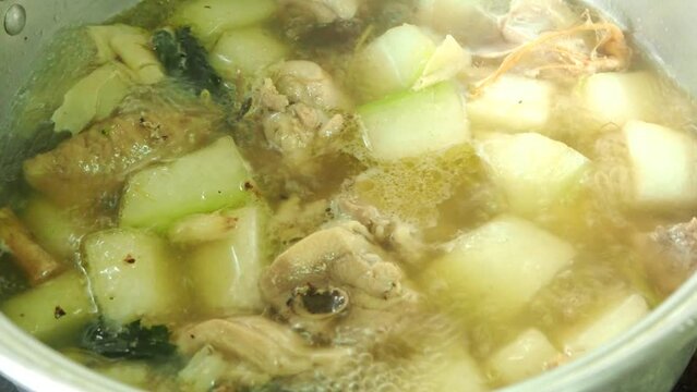 Cooking wax gourd chicken soup in pot, in door  Chiangmai  Thailand.