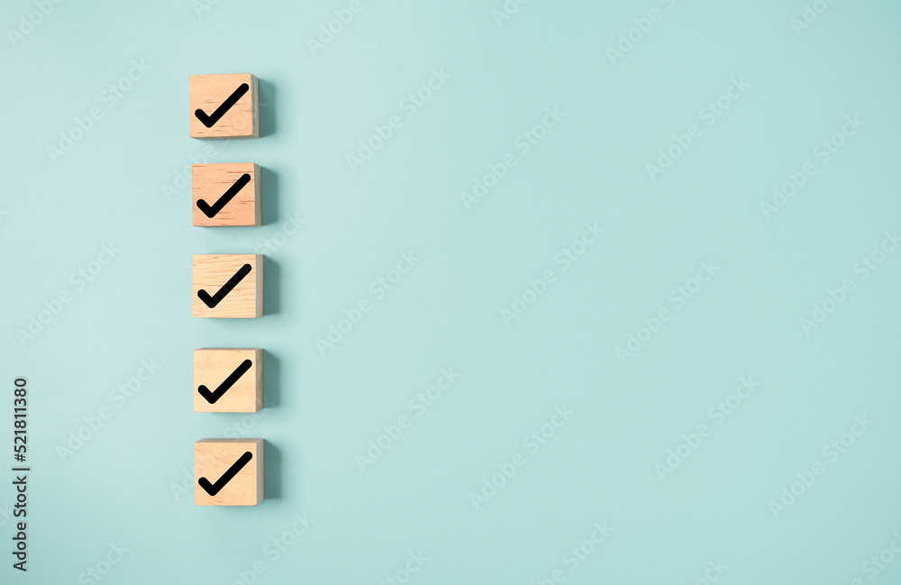 Poster Black correct sign and tick check mark to wooden cube block with copy space for checklist of ISO quality control and approve business product concept.
