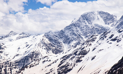 Panorama of a colored mountain landscape with the snow covered mountains - 521812121