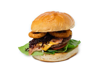 close up beef burger with cheddar cheese and fried onion rings 
