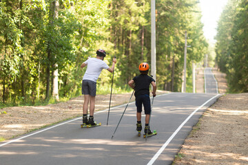 Man ride roller skis in the autumn Park.