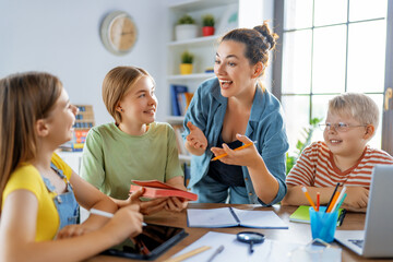 Happy kids and teacher at school