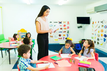 Preschool students listening to their teacher during class