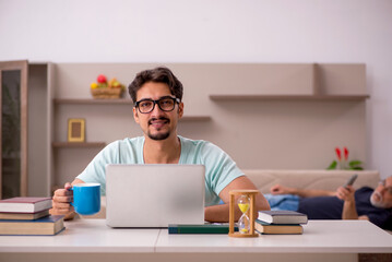 Fototapeta premium Young male student and his grandfather at home