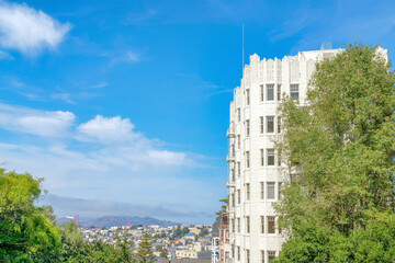 Multi-storey apartment building and a view of San Francisco neighborhood and mountain in California