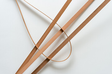 interlocked curved and straight vintage cedar wood straps on white paper