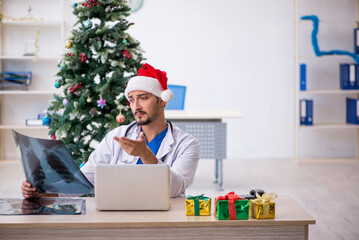 Young male doctor celebrating Christmas at the hospital