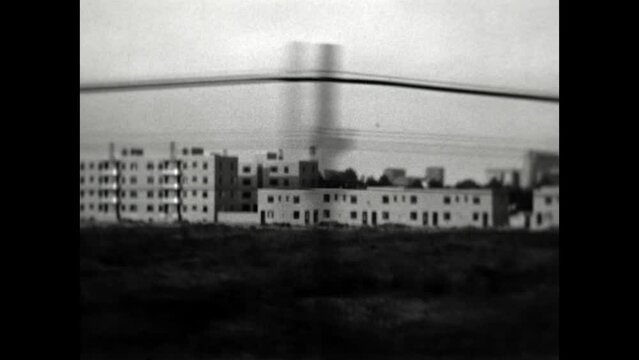 Passing Factories 1937 - Apartment buildings and factories are seen from a train traveling through Illinois in 1937. 