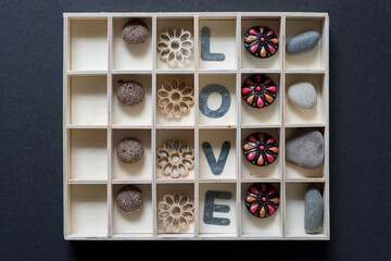 sophisticate display on the allegory of love (button, flowers, letters, fancy buttons, rocks)