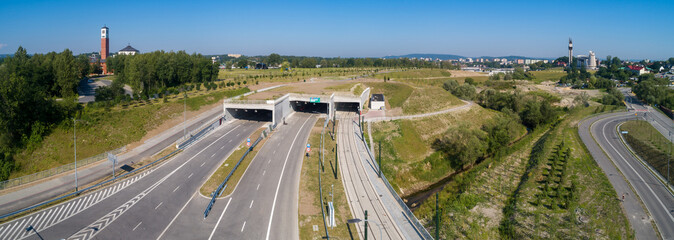 New highway in Krakow, called Trasa Łagiewnicka with multilane road with tunnels for cars and trams, to be opened in July 2022. Part of the ring road around Cracow city center. Aerial panorama
