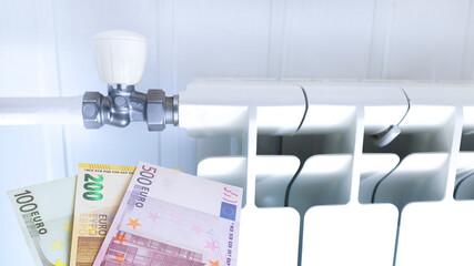 Euro banknotes and heating radiator. EU finances concept.