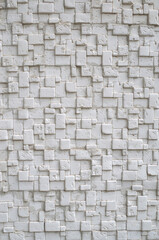White relief tiles imitating stone on wall close
