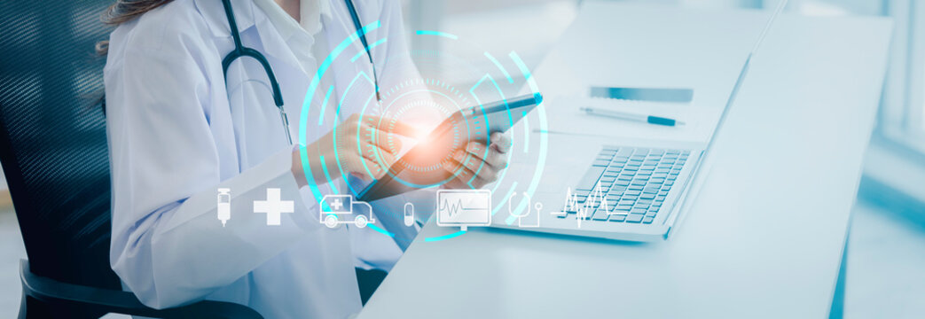 Doctor using digital tablet with medical infographic on virtual hologram display at hospital,Tele-medical health care service concept