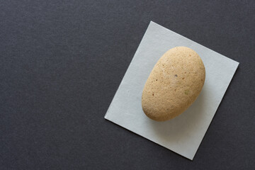 rounded stone (worn brick) isolated on paper
