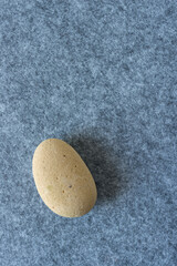 rounded stone (worn brick) isolated on felt