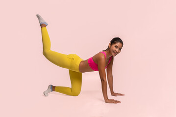 Obraz na płótnie Canvas Full body length shot of smiling young sporty Asian woman fitness model in pink-top sportswear doing side plank exercise raise up leg. Fitness and healthy lifestyle concept.